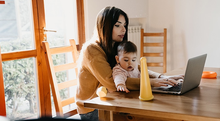Woman at computer with child